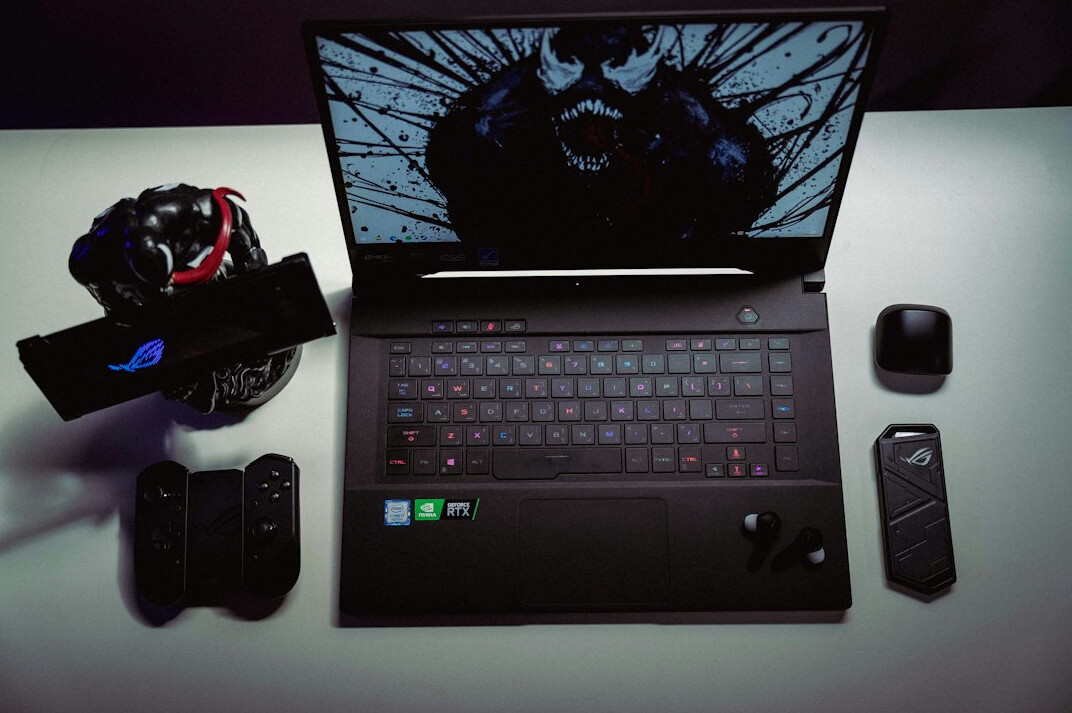 Close-up of hands typing on a laptop keyboard with code editor on screen
